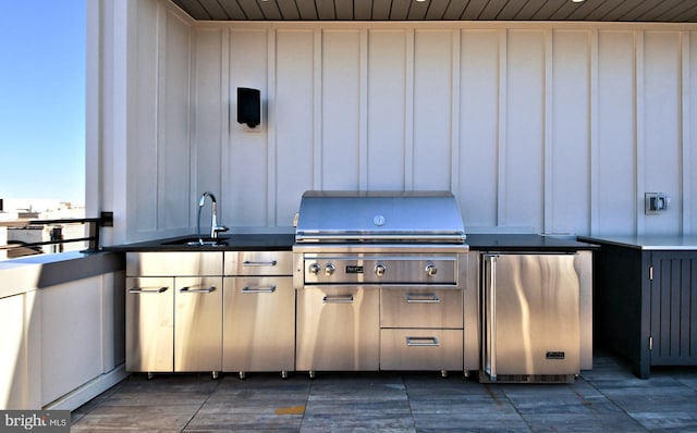 view of patio / terrace with grilling area and sink