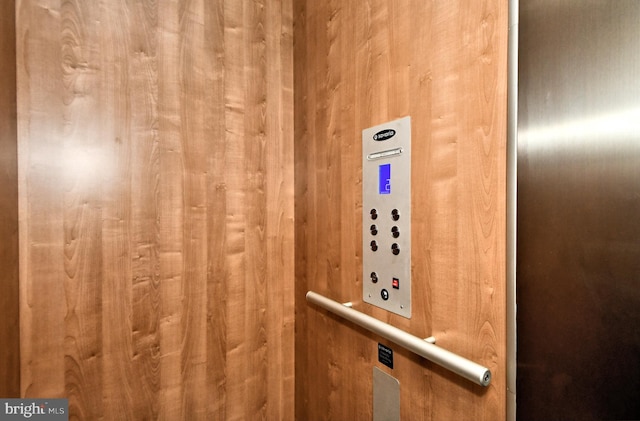 interior details featuring wood walls and elevator