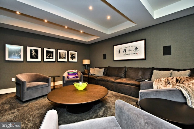 living room featuring carpet and a tray ceiling