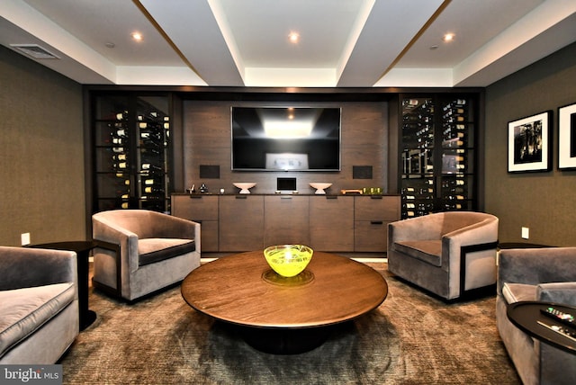 wine room with carpet floors and a tray ceiling