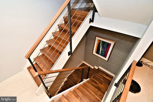 stairs with hardwood / wood-style flooring