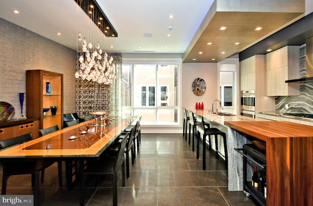 dining room featuring sink and a wealth of natural light