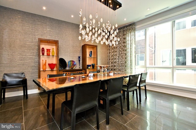 tiled dining room with an inviting chandelier