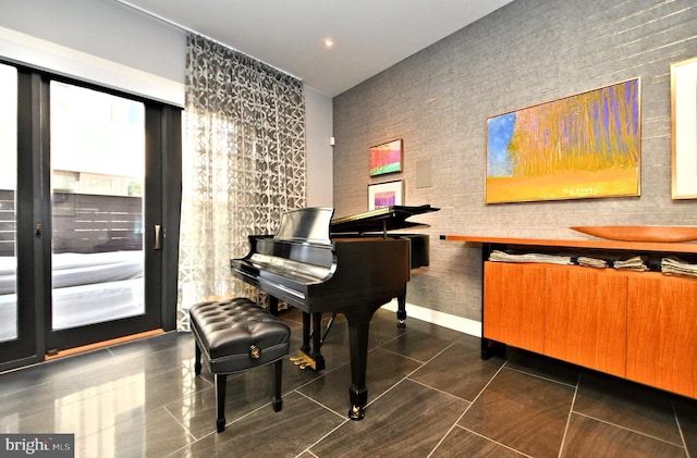 misc room with dark tile patterned floors