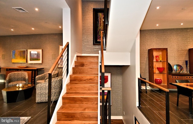 staircase with wood-type flooring