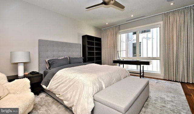 bedroom with hardwood / wood-style floors and ceiling fan