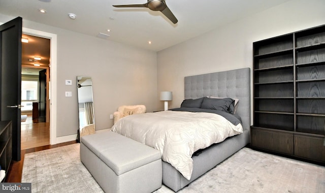 bedroom with ceiling fan and light wood-type flooring