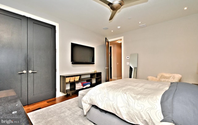 bedroom featuring a closet, hardwood / wood-style flooring, and ceiling fan