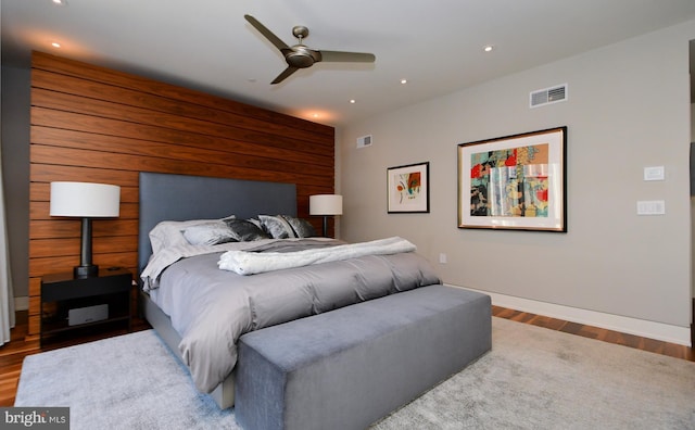 bedroom with ceiling fan and wood-type flooring