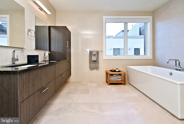 bathroom featuring vanity and a tub