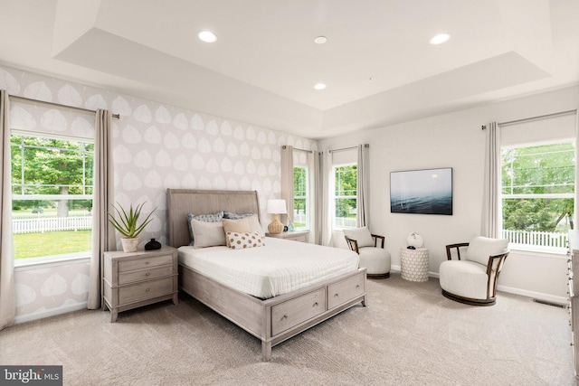 carpeted bedroom featuring recessed lighting, wallpapered walls, baseboards, and a tray ceiling