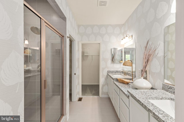 full bathroom with visible vents, a stall shower, a spacious closet, and wallpapered walls