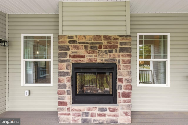 exterior details featuring stone siding and a glass covered fireplace