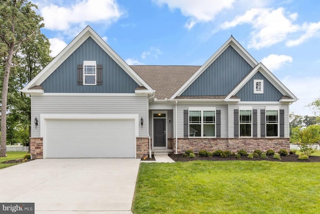 craftsman-style house with a front yard, driveway, roof with shingles, stone siding, and board and batten siding