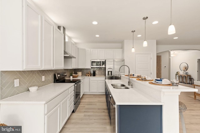 kitchen with arched walkways, white cabinets, stainless steel appliances, and a sink