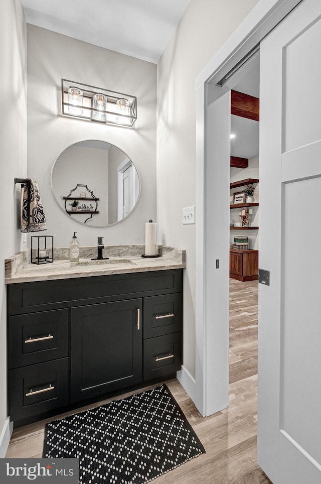 bathroom with vanity and wood-type flooring