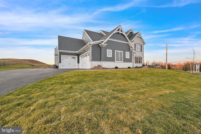 view of front of home featuring a garage and a front lawn