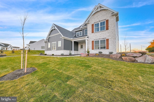 craftsman inspired home with a front lawn