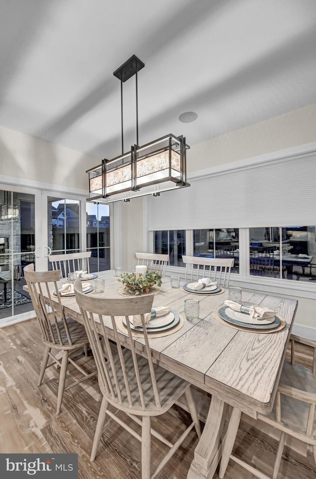 dining area featuring french doors and wood-type flooring