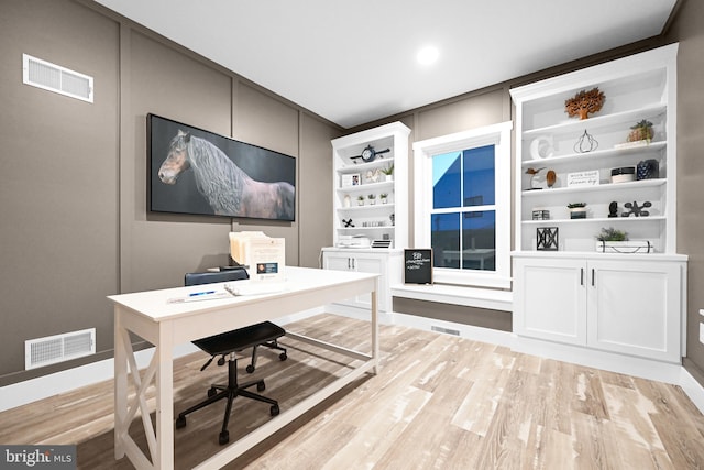 office area featuring built in shelves and light wood-type flooring