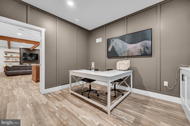 office area featuring beam ceiling and light hardwood / wood-style floors