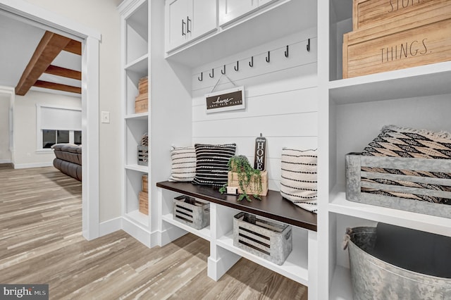 mudroom with beamed ceiling and light hardwood / wood-style flooring