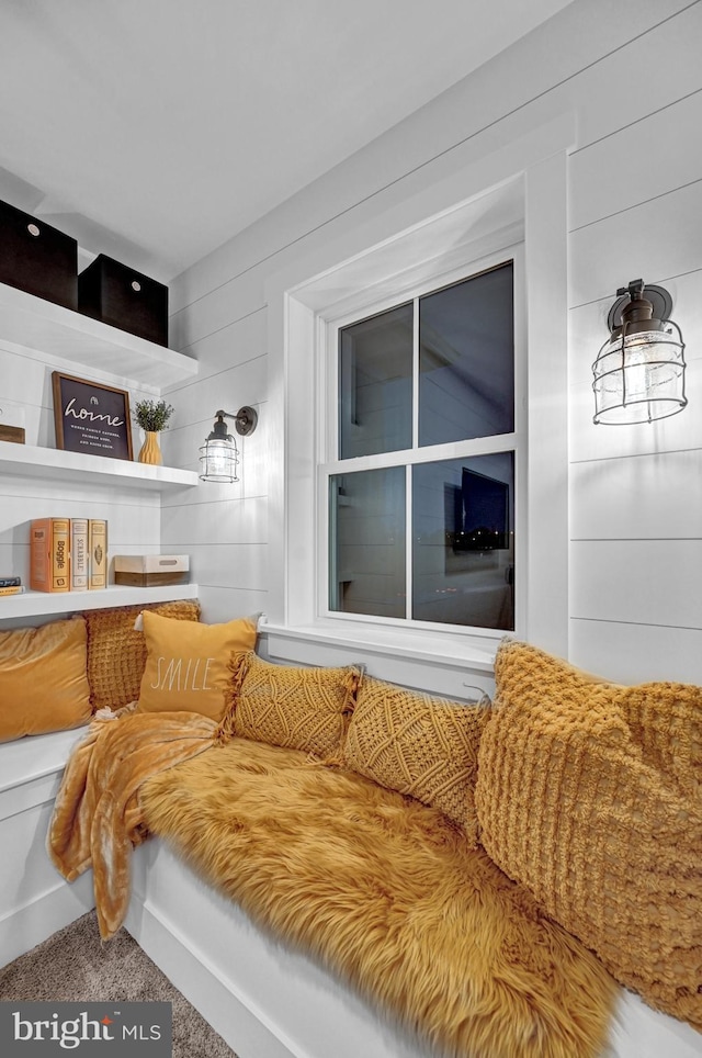 interior space with carpet floors and wood walls