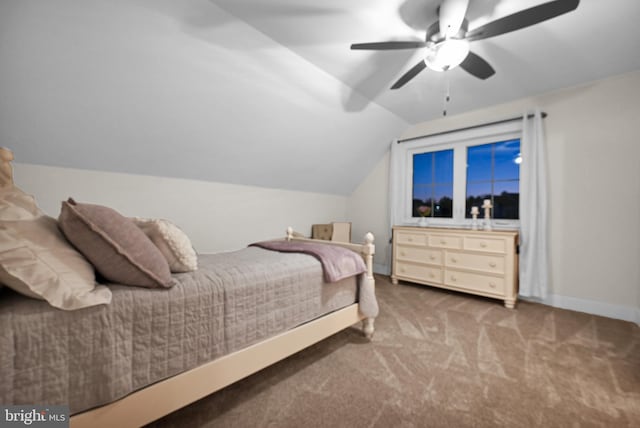 carpeted bedroom with vaulted ceiling and ceiling fan