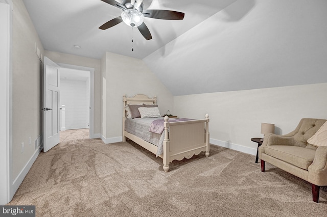 carpeted bedroom with vaulted ceiling and ceiling fan