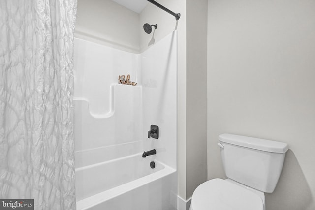 bathroom featuring shower / tub combo with curtain and toilet