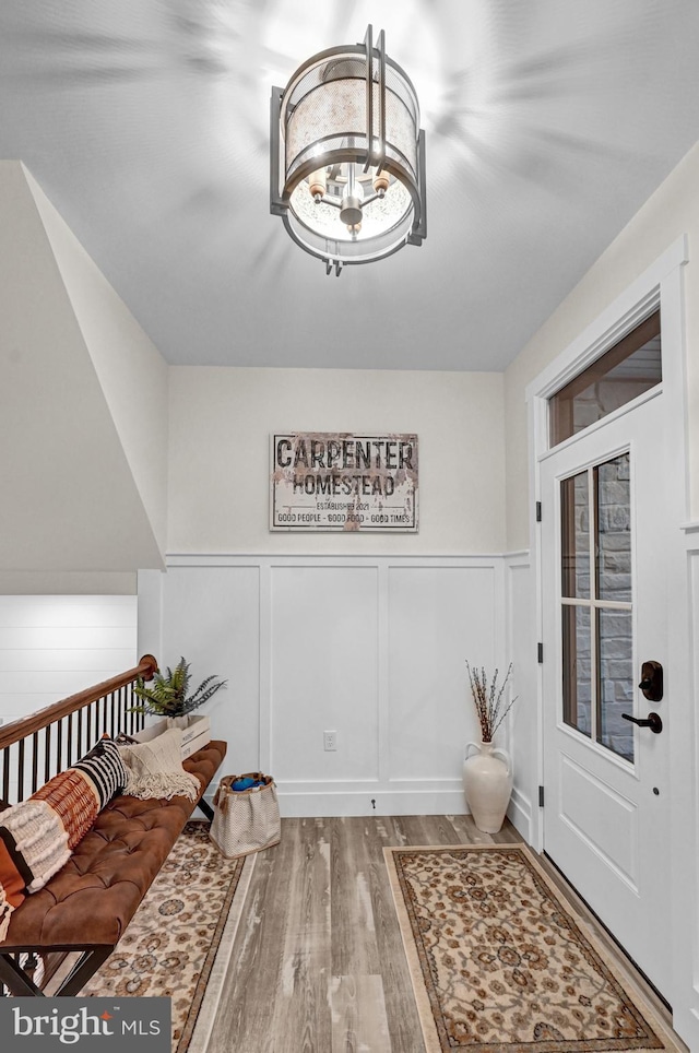 interior space featuring hardwood / wood-style flooring and an inviting chandelier