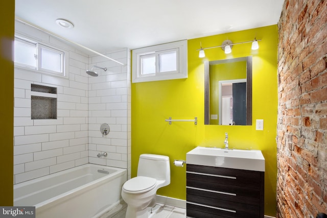 full bathroom featuring vanity, toilet, and tiled shower / bath combo