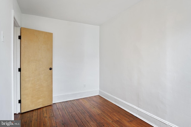 spare room featuring wood-type flooring