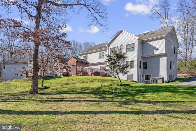 rear view of property featuring a yard