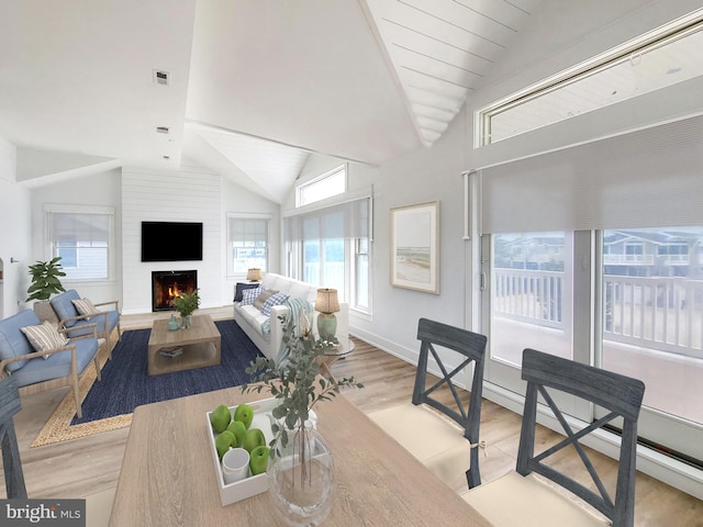 living room with a fireplace, light wood-type flooring, and lofted ceiling