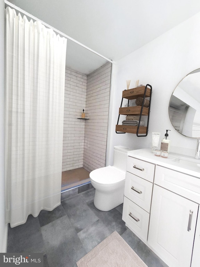 bathroom featuring toilet, vanity, and walk in shower