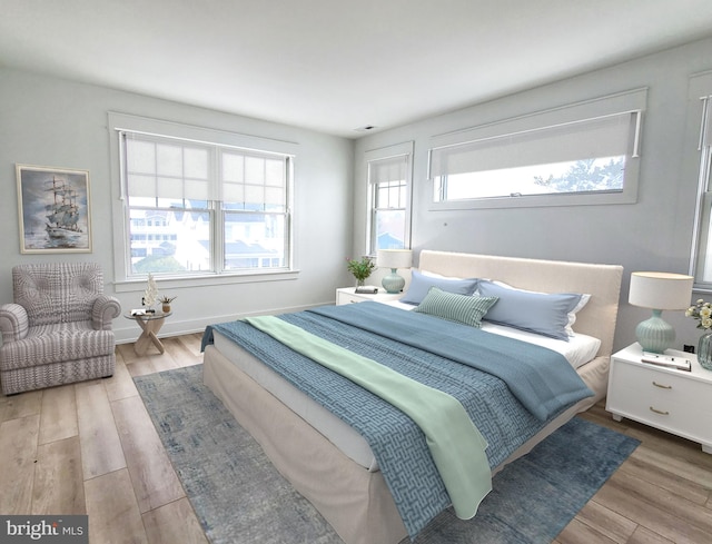 bedroom featuring light hardwood / wood-style floors and multiple windows