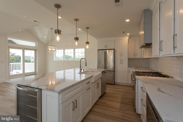 kitchen with premium range hood, a kitchen island with sink, wine cooler, premium appliances, and white cabinetry