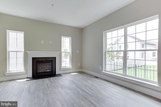 unfurnished living room with light hardwood / wood-style flooring