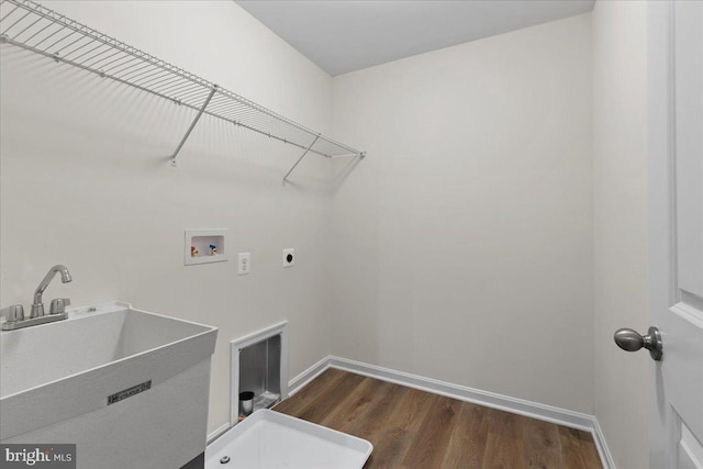 laundry area with washer hookup, dark wood-type flooring, electric dryer hookup, and sink