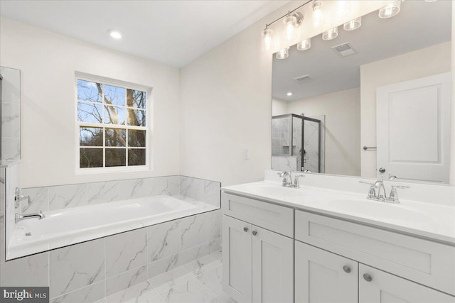 bathroom featuring shower with separate bathtub and vanity