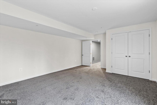 interior space featuring dark colored carpet