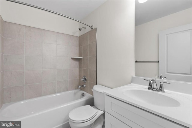 full bathroom with toilet, vanity, and tiled shower / bath combo