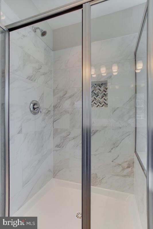 bathroom featuring a shower with door