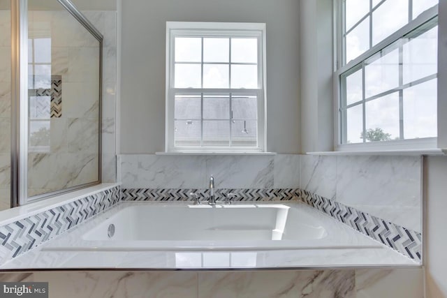 bathroom with tiled tub