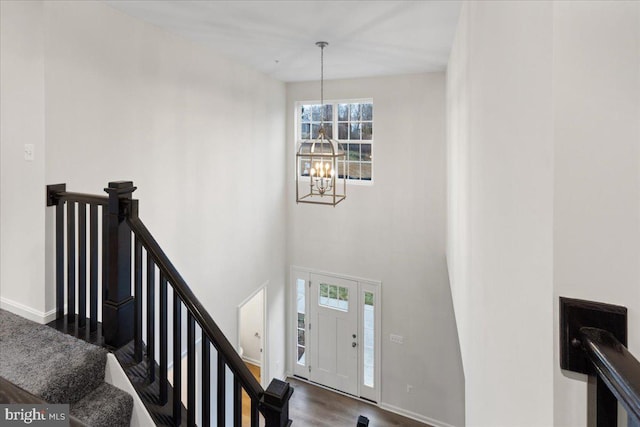 entryway featuring a chandelier, dark hardwood / wood-style flooring, and a wealth of natural light