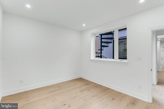 unfurnished room with light wood-type flooring