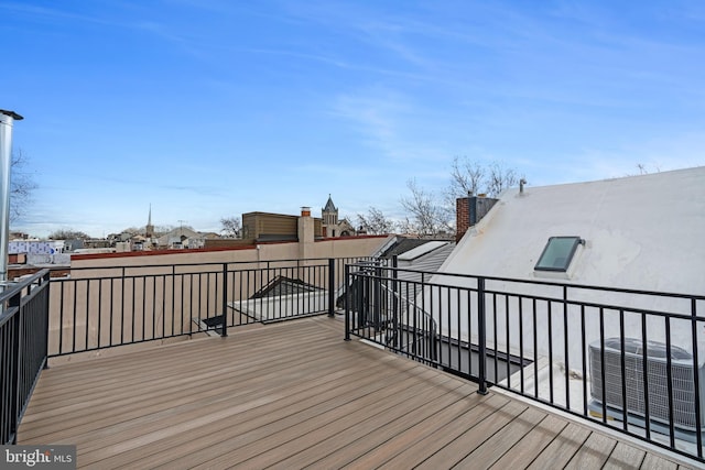 wooden deck featuring cooling unit