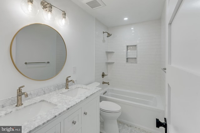 full bathroom with vanity, toilet, and tiled shower / bath