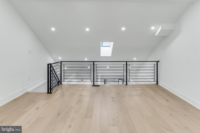 bonus room featuring a skylight and light wood-type flooring